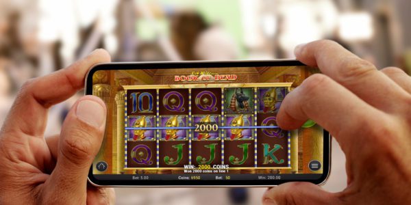 Close up on male hands taking photo of sea coast with mobile cell phone. Summer beach holiday vacation concept