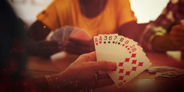 a hand of cards at the table