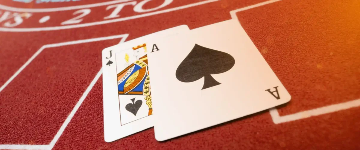 blackjack strategy featured image, two cards on a blackjack table